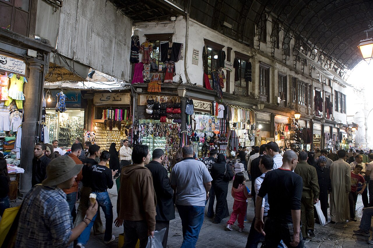 A covered arcade of Al-Hamidiyah Souq in Damascus with shops on either side